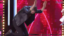 Man bows and claps on stage