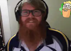 Bearded man with headphones strokes his beard
