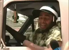 Dave Chappelle laughing in a car