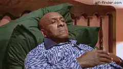 Man lying in bed eyes widen in shock