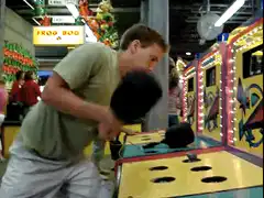 Man playing arcade whack-a-mole game