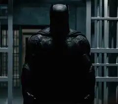 Batman standing in prison