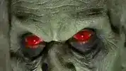 Green zombie with glowing red eyes