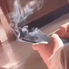 Person holding a smoking smartphone