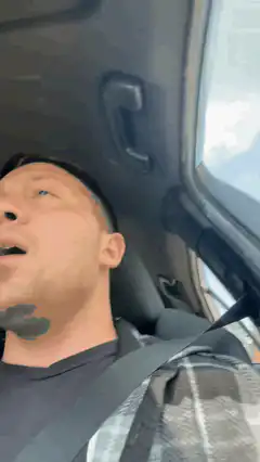Man yawning in car