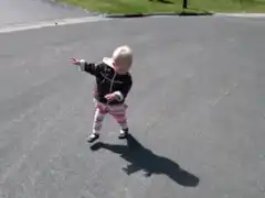 Toddler walking and waving