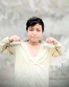 Boy adjusting shirt collar
