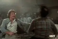 Man in saloon punches another man