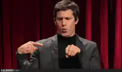 Andy Samberg pointing at himself