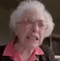 Old lady squinting and grimacing