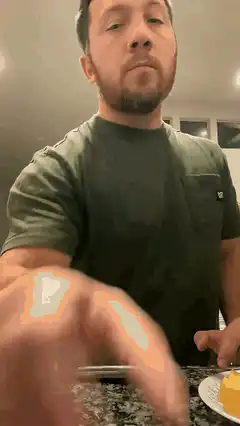 man cutting block of cheese