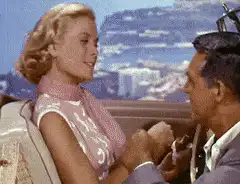 Grace Kelly and Cary Grant kiss in a car