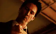 Neo lights a cigarette in The Matrix