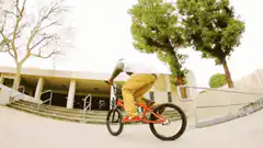 BMX rider does a manual over stairs
