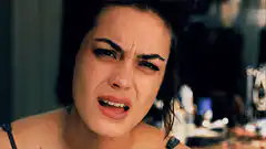 Woman crying and grimacing