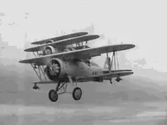Three biplanes flying in formation