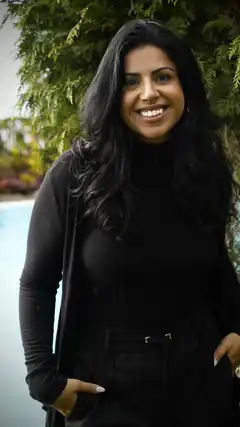 Smiling woman in black outfit