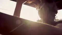 Woman in car with sun flare