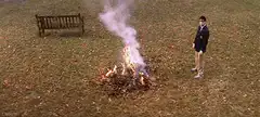 Man standing by a bonfire