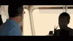 Man talking to another man on a boat