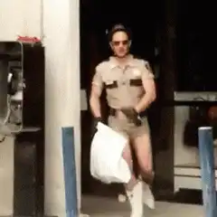 Man in police uniform running with white bag