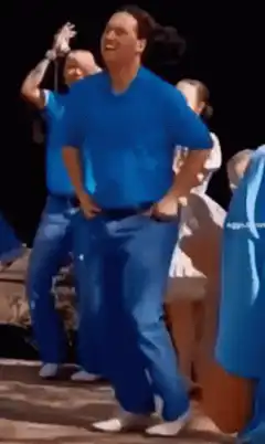 Man in blue shirt dancing on stage