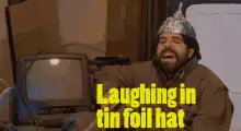 Man in tin foil hat laughing