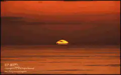 Sun rising over ocean