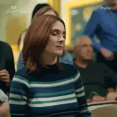 Woman in striped sweater says yes and points