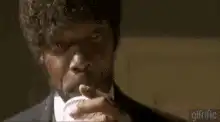 Jules Winnfield drinks coffee and smiles