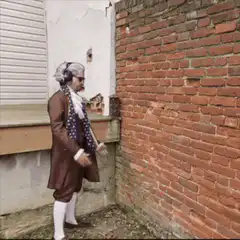 George Washington touching brick wall