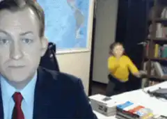 Man in suit with dancing child in background
