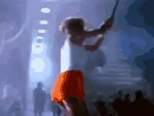 Woman hits giant face on screen with bat