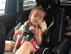 Sleepy girl dancing in car seat