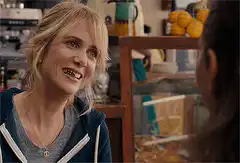 Two women making funny faces in a cafe