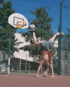Girl does handstand with soccer ball