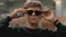 Tobey Maguire puts on sunglasses