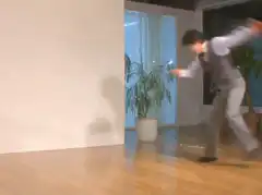 Man in vest does a headspin