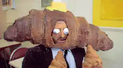 Man with croissant head and googly eyes