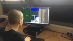 guy at computer gives thumbs up
