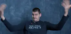 Man in We Are 420 shirt shrugging