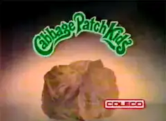 Cabbage Patch Kid emerges from cabbage