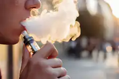 person vaping with large cloud