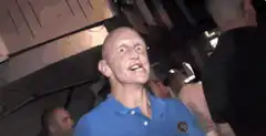 Bald man making crazy faces and hand gestures