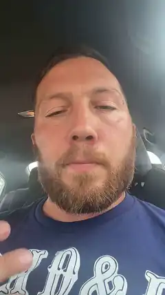 bearded man in car with eyes closed