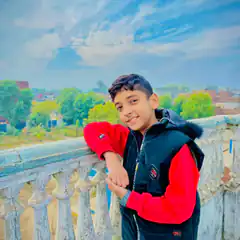 Boy in red and black jacket on balcony