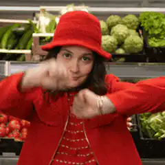 Woman in red hat dancing in grocery store