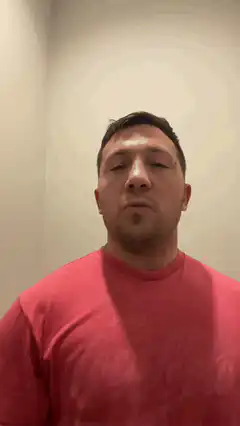 Man in red shirt closing eyes