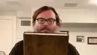 Jack Black reads a glowing book