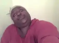 man in pink hoodie tilting head